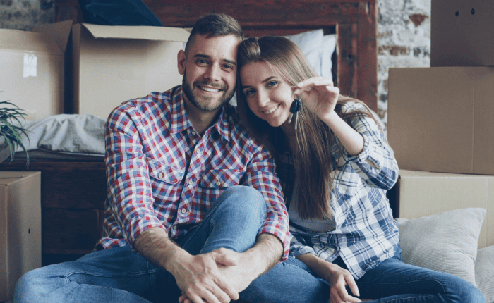 New home owners smiling with house keys in their hand